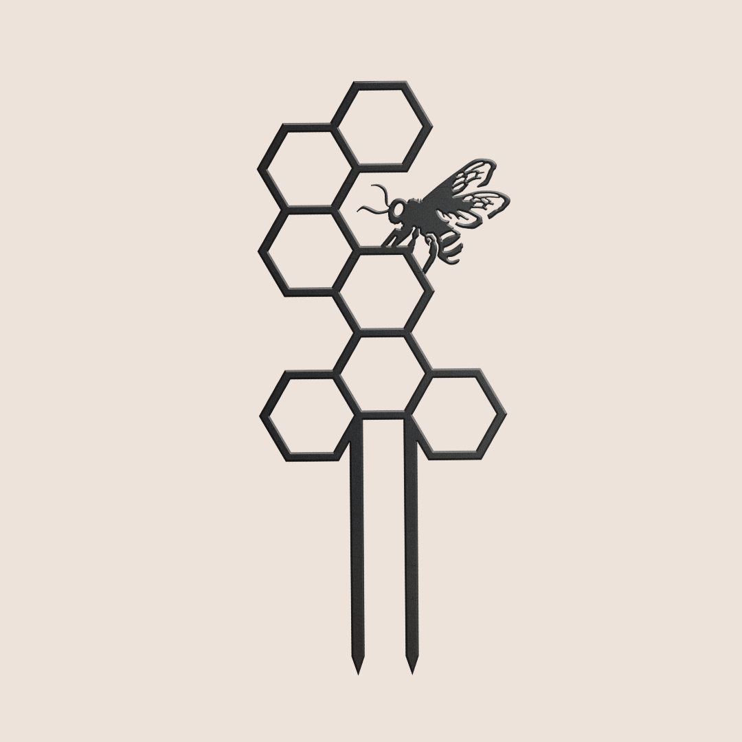 The Honeybee Plant Trellis by Metalbird UK features a minimalist black honeycomb with a detailed bee on a hexagon, set on light beige. Two corten steel stakes make it ideal as modern garden art.