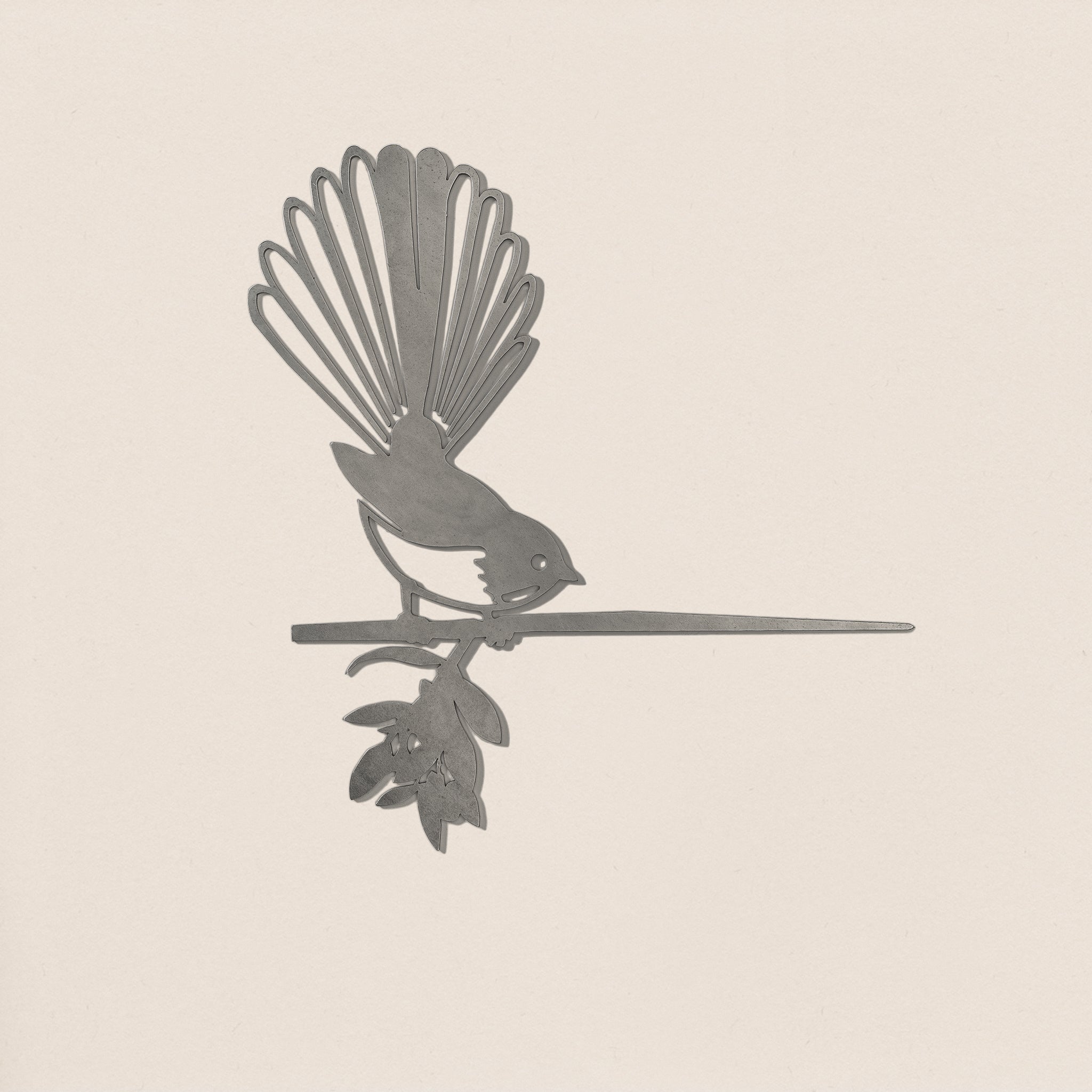 Fantail (Piwakawaka) by Metalbird UK is a corten steel silhouette of a bird with a fanned tail perched on a leafy branch—ideal as unique garden art.