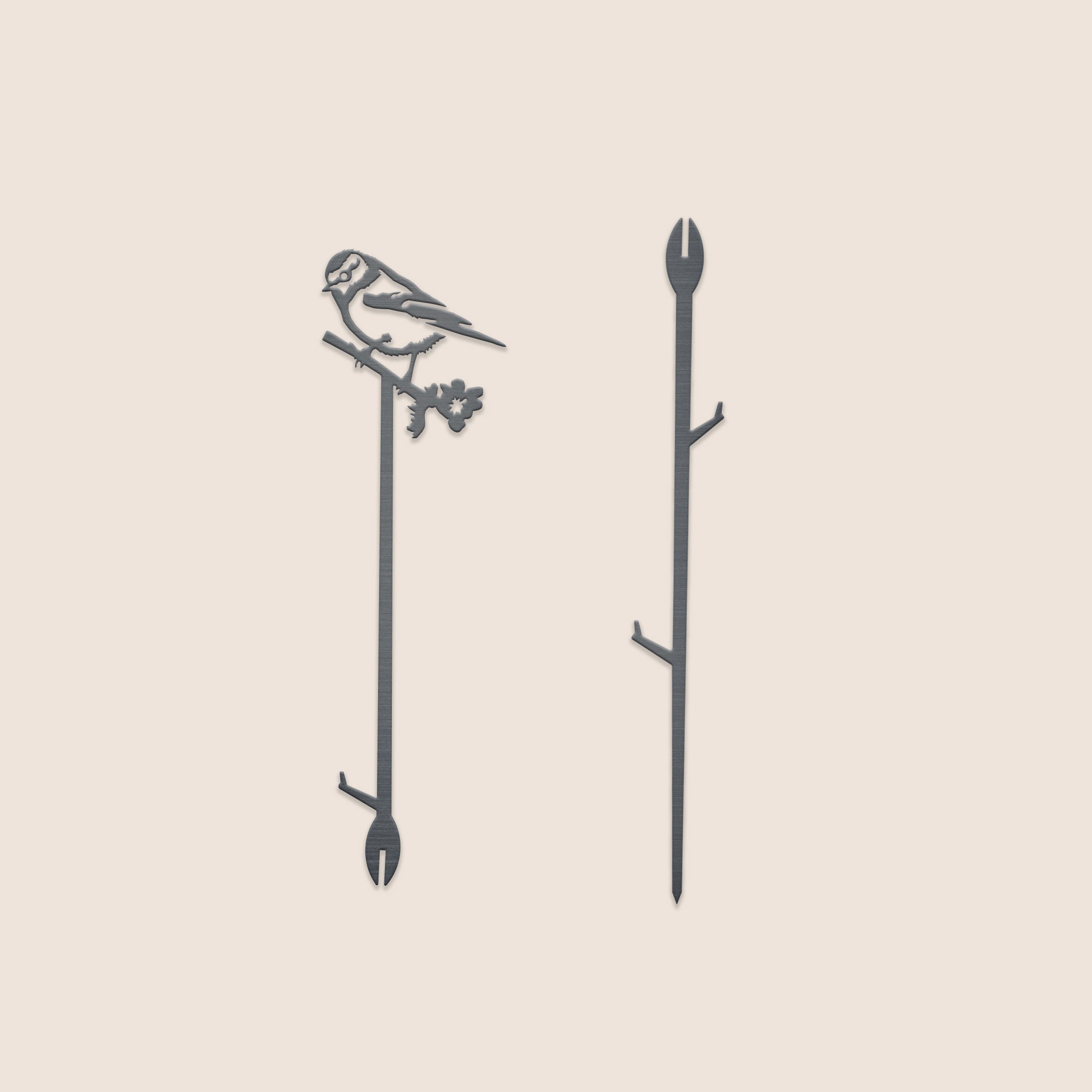 Two Metalbird UK garden stakes are shown. One features a perched Blue Tit silhouette atop a branch, while the other has subtle branch details. Both are 70cm tall with pointed ends—an ideal gift for garden lovers.