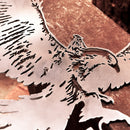 A close-up of Metalbird UK's GANDALF™ ON GWAIHIR™, a premium corten steel sheet sculpture intricately cut to depict Gandalf on Gwaihir, displayed on a copper-toned textured surface.