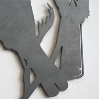 Close-up of the Metalbird Seconds - Robin by Metalbird UK, a minimalist metal bird ornament with overlapping feet, mounted on a white wall—ideal for fans of stylized bird decor.