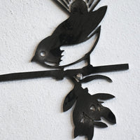 Metalbird UK’s Metalbird Seconds - Robin Pair features two birds perched on a branch with leaves and flowers—an ideal choice for unique metal bird ornaments or discounted garden decor, mounted on any textured wall.