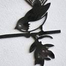 The Metalbird UK "Metalbird Seconds - Fantail" is a unique black metal wall art of a stylized bird on a branch, featuring imperfections—perfect as discounted garden decor.