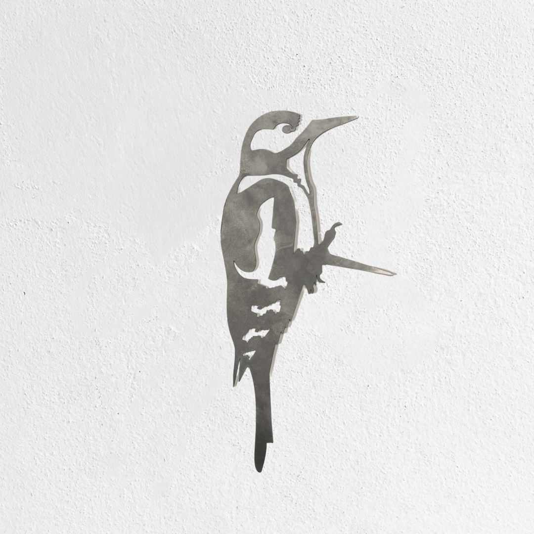 The Metalbird UK "Great Spotted Woodpecker - Seconds" is a premium metal silhouette with clean lines, depicting the bird in profile and upright, mounted on a textured white wall.
