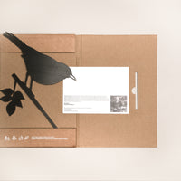 The Blackbird folder by Metalbird UK features a black bird silhouette holding a white card, with recycling and eco-friendly icons at the bottom—an ideal gift for those who care about the environment.