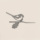 The Metalbird UK Long-tailed Tit is a sleek gray corten steel silhouette of a small bird perched on a branch with an oak leaf—ideal as unique yard art or a thoughtful gift.