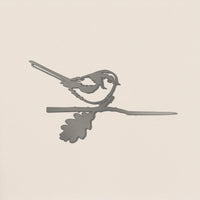 The Metalbird UK Long-tailed Tit is a sleek gray corten steel silhouette of a small bird perched on a branch with an oak leaf—ideal as unique yard art or a thoughtful gift.