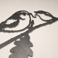 The Long-tailed Tit & Chick by Metalbird UK is a corten steel wall art featuring two birds on an oak branch in silhouette, set against a plain light background.