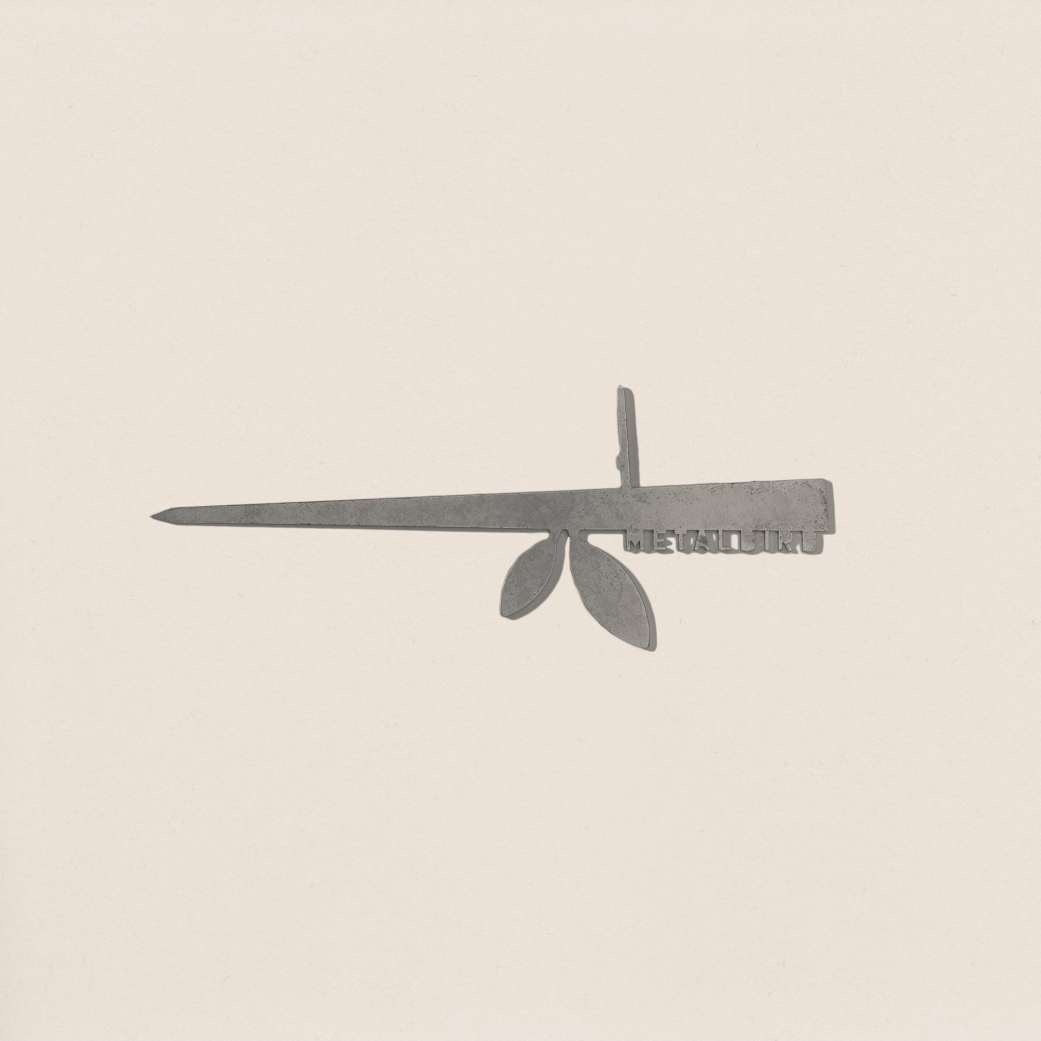 A minimalist illustration of the Stick Feeder by Metalbird UK features a striking silhouette resembling a Swiss Army knife with a blade, key, and leaves against an off-white background.
