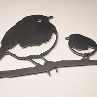 Robin and Chick" by Metalbird UK is a minimalist metal wall art featuring a large robin and a chick perched on a branch, making it an ideal garden decoration or thoughtful gift for nature lovers.