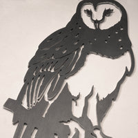 The Barn Owl by Metalbird UK is a metal cutout silhouette of an owl perched on a branch, featuring stylized perforated feather and face details—an eye-catching piece for your garden or wall.