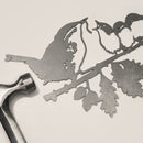 The Wren and Chicks by Metalbird UK features a corten steel cutout of a bird feeding its three chicks on a leafy branch—perfect as unique garden art or a thoughtful gift.