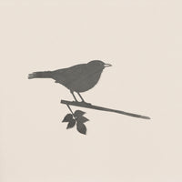 Blackbird by Metalbird UK features a sleek black silhouette of a small bird perched on a leafy branch against an off-white background—an ideal garden art piece or thoughtful gift for nature lovers.