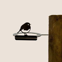 The Bowl Bird Feeder by Metalbird UK is a stylish metal yard art piece featuring a bird perched on a circular frame. Easily attach it to any wooden post for an elegant outdoor accent or thoughtful gift.