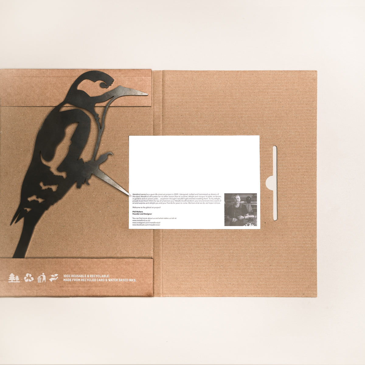 Great Spotted Woodpecker silhouette laid across open cardboard packaging with an information card.
