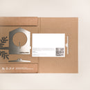An open cardboard package from Metalbird UK holds a flat metal Bird Feeder kit, a white instruction card, and leaf cutouts on a light background—the perfect eco-friendly gift for garden art lovers.