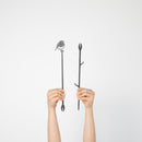 Two hands hold up Metalbird UK's Robin Plant Stake - 70cm against a white background: one features a bird silhouette, the other has branch details—an ideal unique gift or creative accent for your yard art collection.