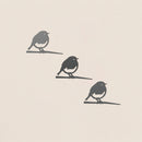The Baby Bird Bundle - Robin Trio by Metalbird UK features three minimalist black metal robin silhouettes perched on branches—ideal as striking yard art or a thoughtful gift.